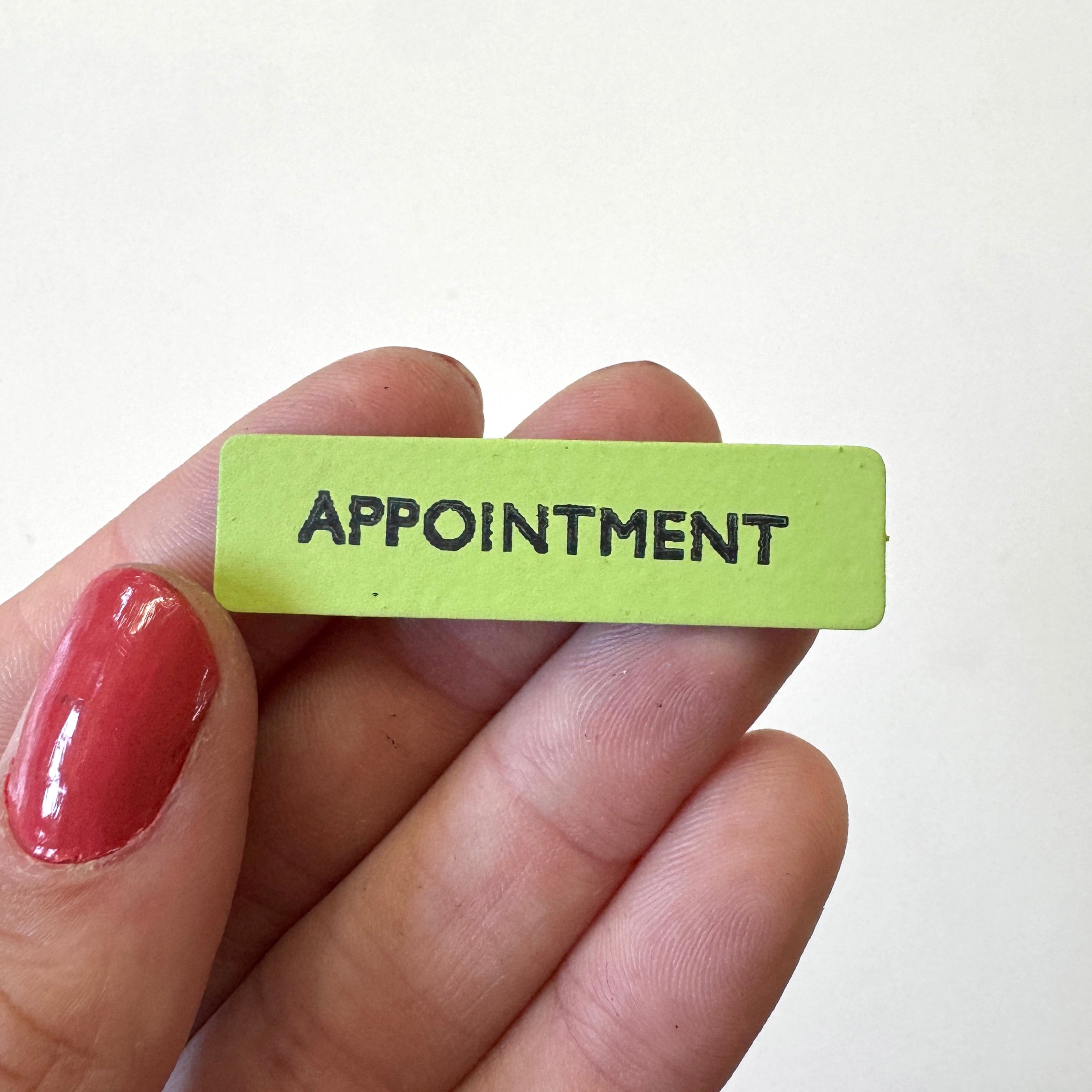 A small rectangular lime green magnet with the word &